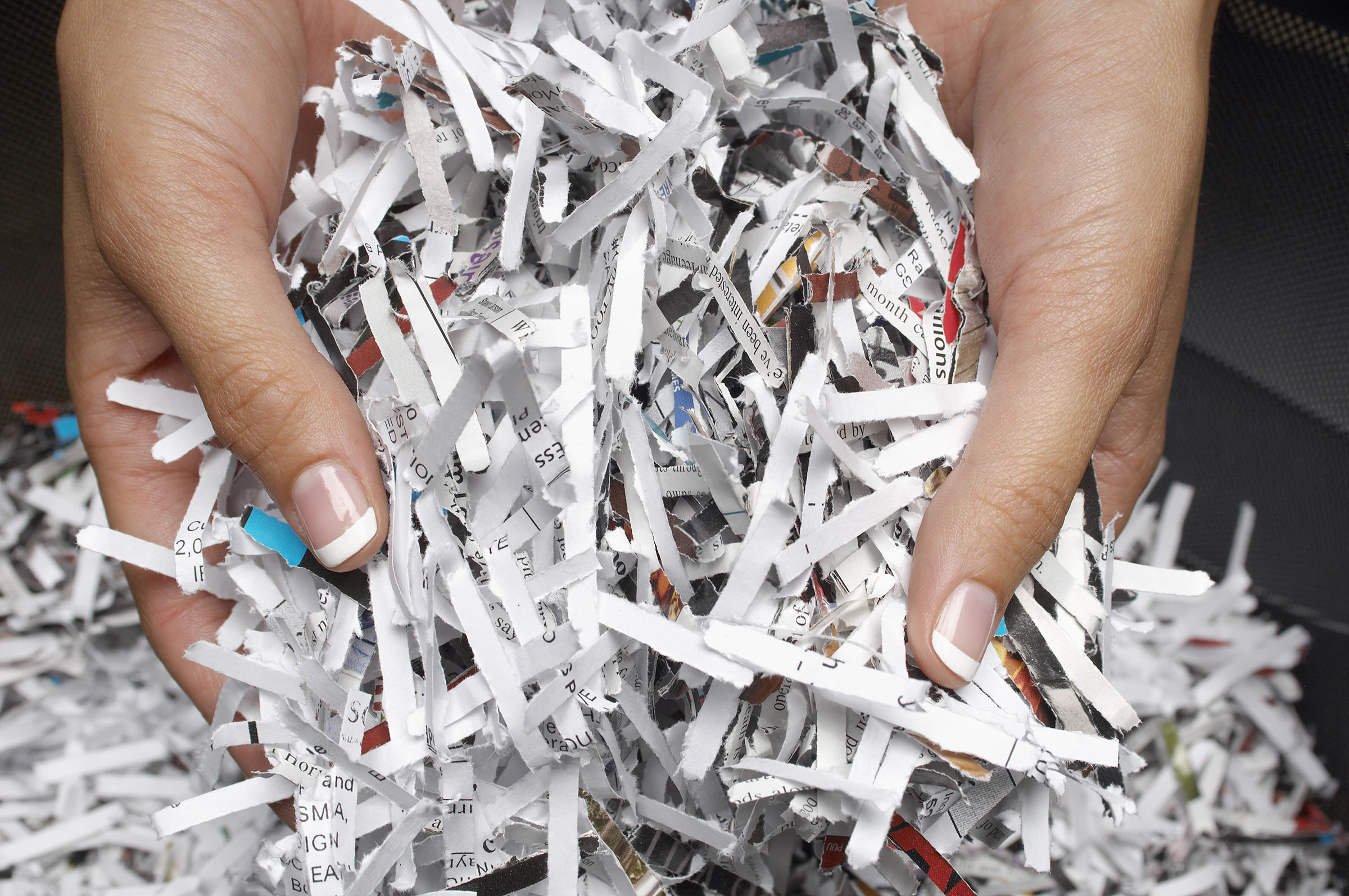 Hands holding shredded paper