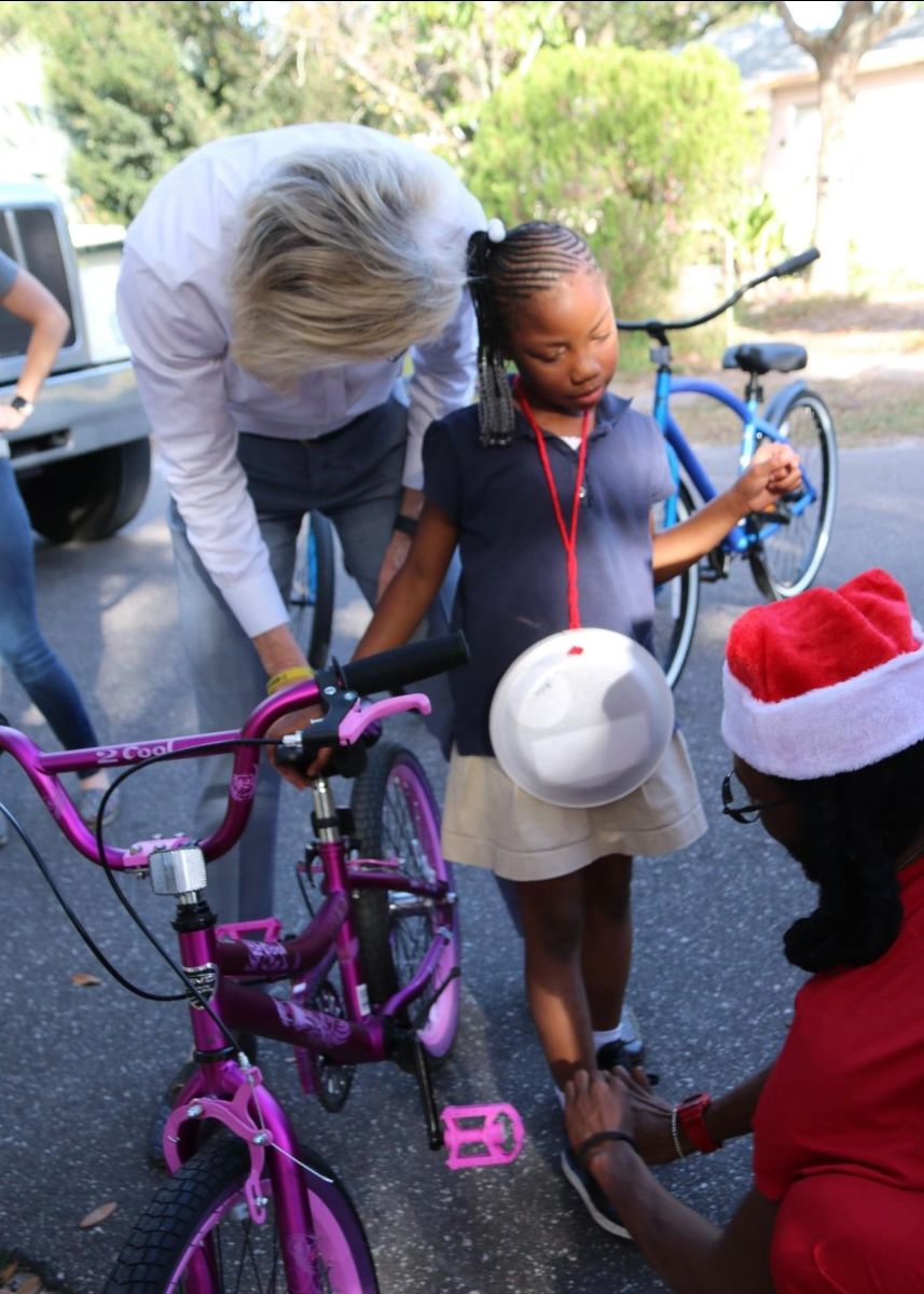Volunteers help make sure every child has a bike adjusted to their height.