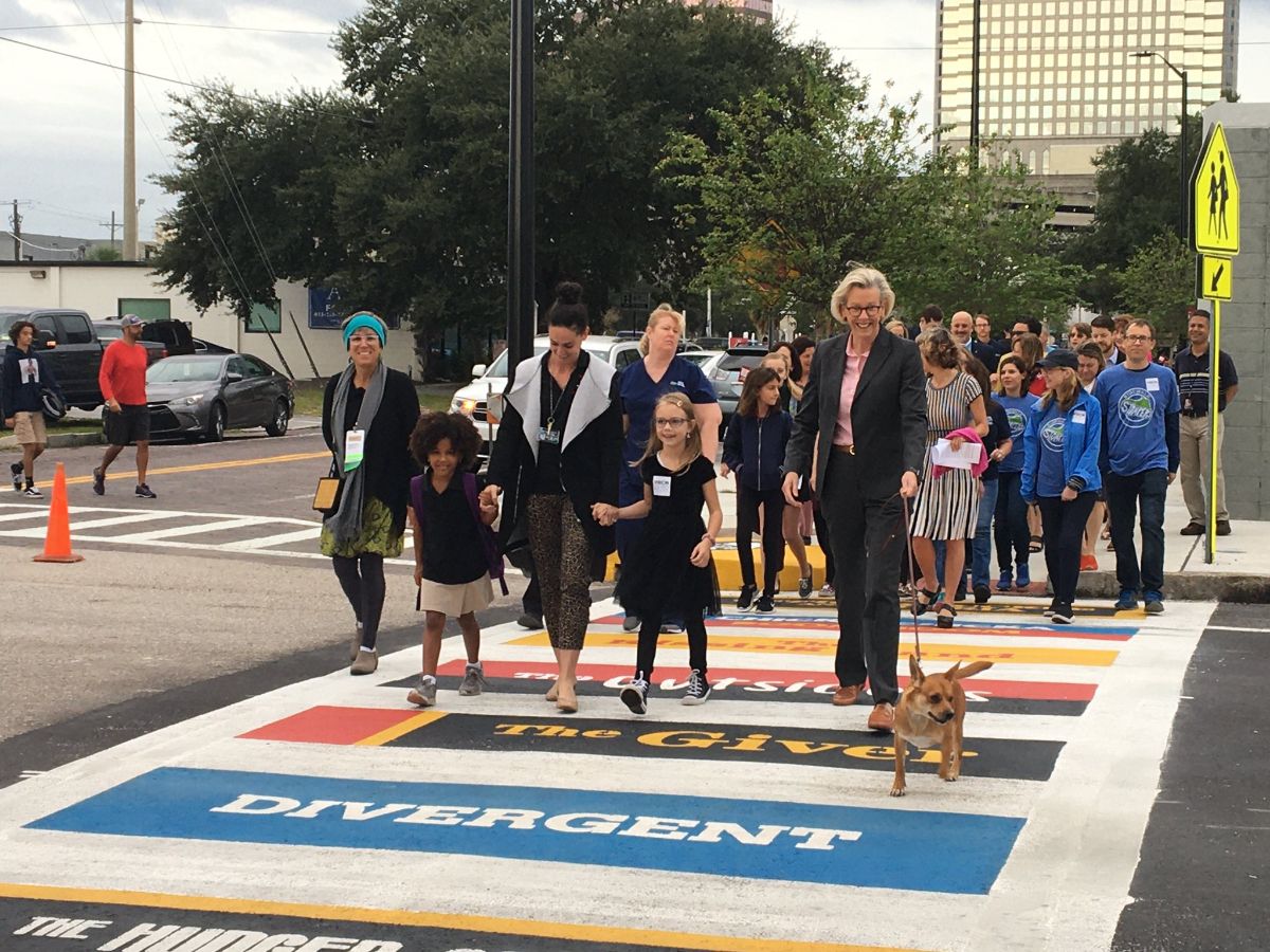 Mayor Jane Castor, Hillsborough County School students and administrators and Desa the Office Dog celebrate the first Crosswalks to Classrooms Mural at Rampello K-8 in Downtown Tampa.