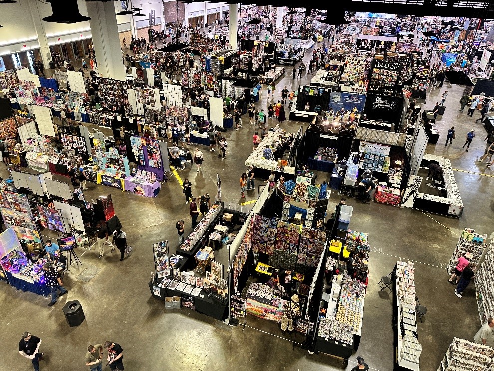 Overhead view of exhibit hall filled with vendors and attendees.