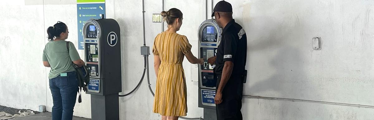 Parking security assisting customer in Poe Garage