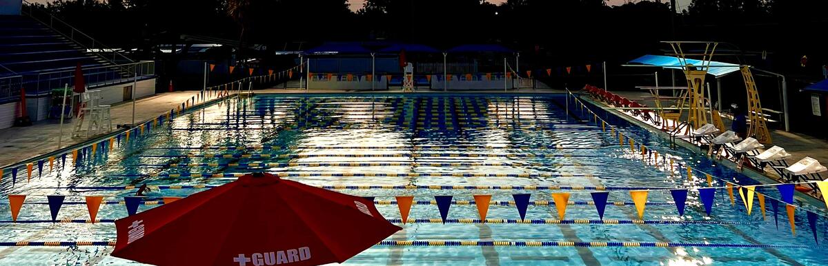 Bobby Hicks Pool at sunrise with colorful lane markers and a lifeguard chair.