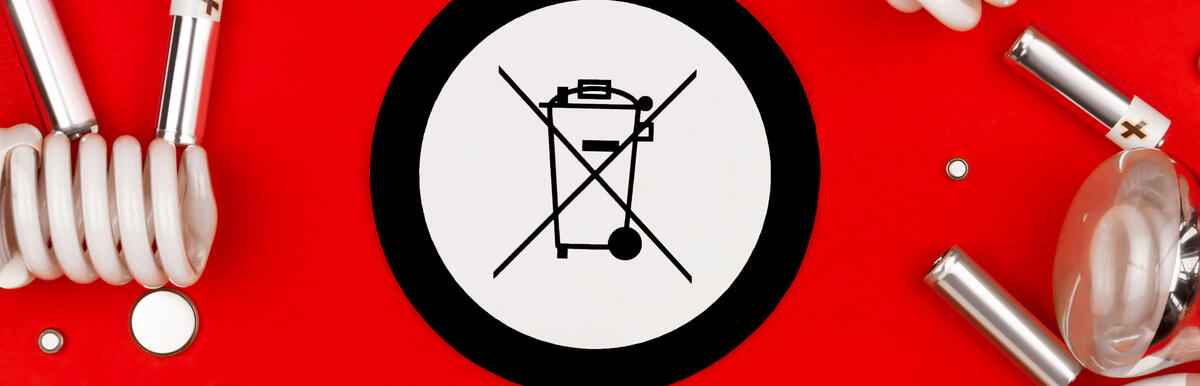 Broken light bulbs around a crossed-out trash bin symbol on a red background.