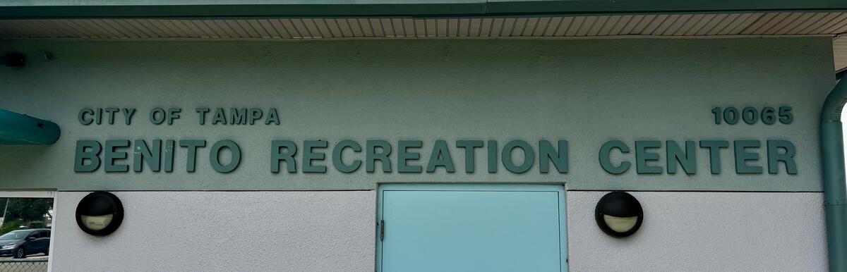 Benito Recreation Center building entrance with teal door and signage.