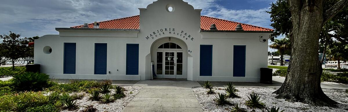Historic white building with a red roof, blue shutters, and "Virginia Suite" sign above entrance.