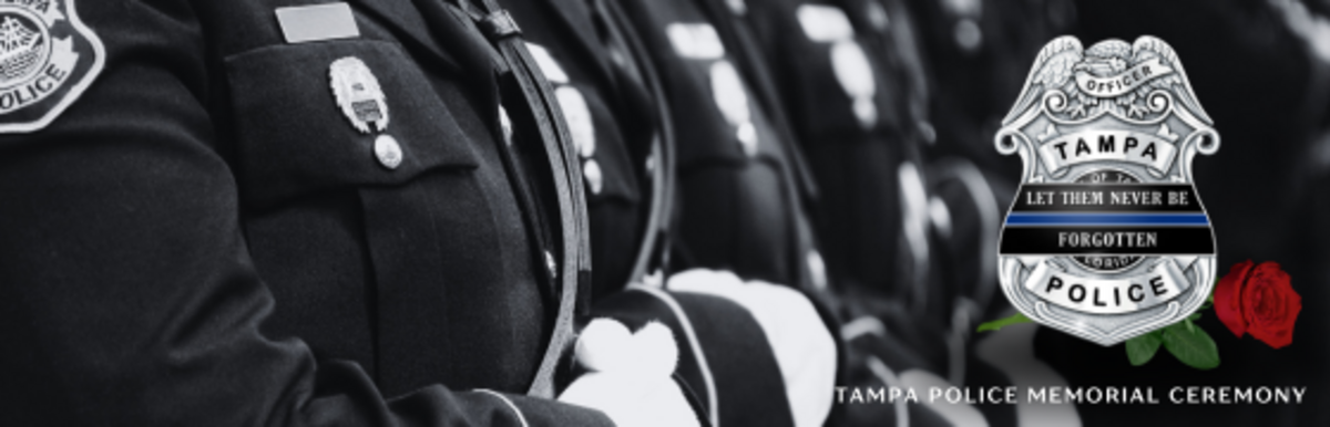 Police memorial ceremony with badge and a red rose.