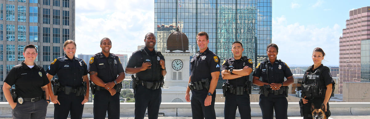 Eight Tampa Police officers and a police K9 dog on Tampa rooftop