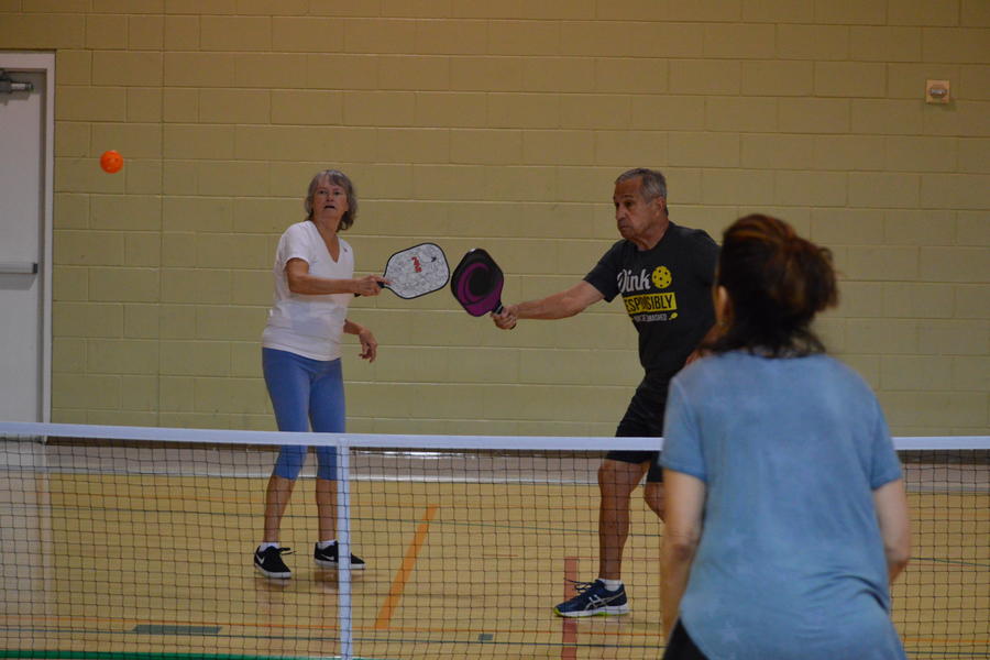 Players in action playing pickleball