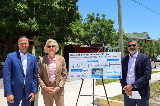 Cleveland Street to Become Safer - Mayor Castor standing next to Cleveland Street Quick Build Project Board