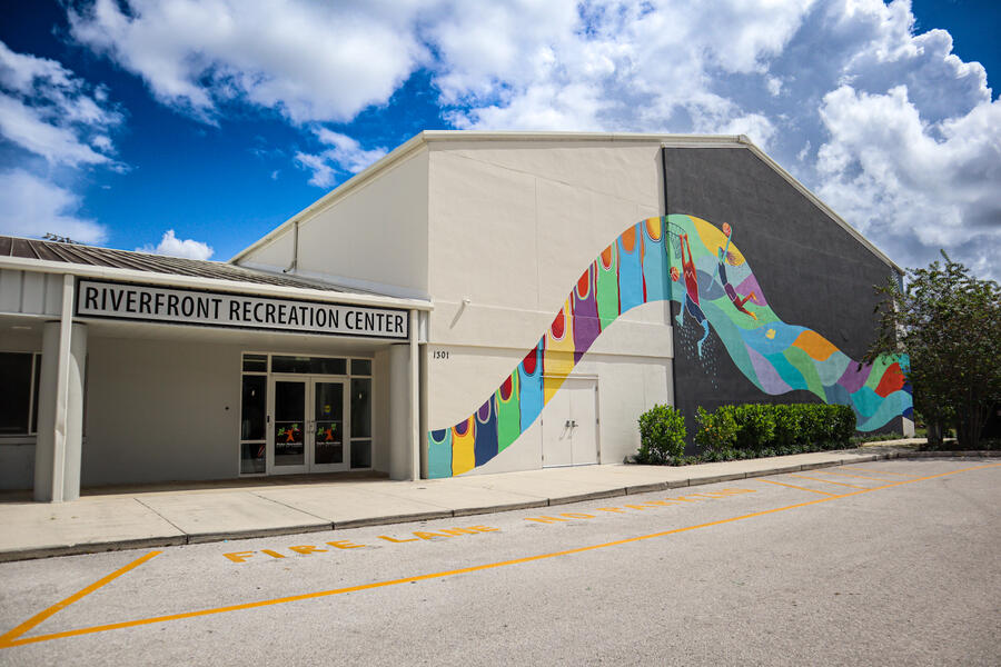 Riverfront Recreation Center with colorful mural and clear sky.