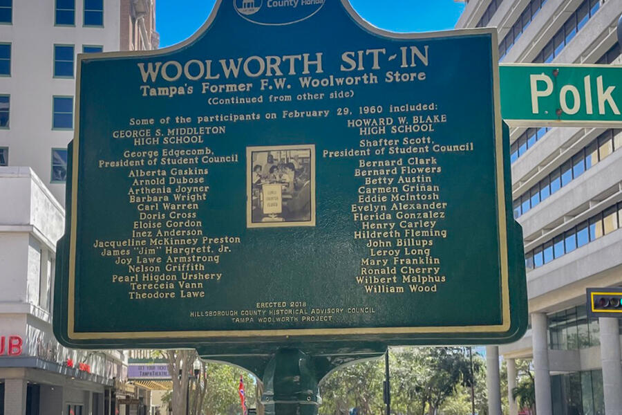 Woolworth Sit-In historical marker listing participants and location in downtown setting.