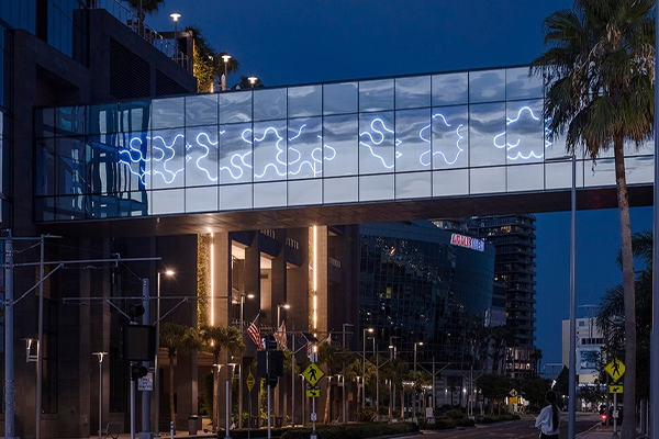 Sky bridge at night with glowing blue wavy patterns reminiscent of haloclines.