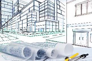 Architectural blueprints and drawing tools in front of a commercial building design sketch.
