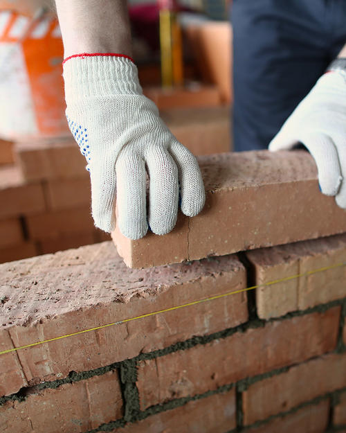 Community Redevelopment Areas Gloved hands building with bricks