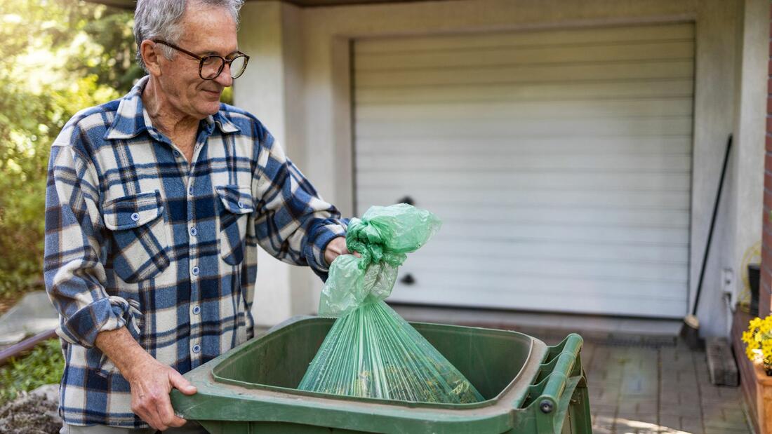 senior taking out garbage