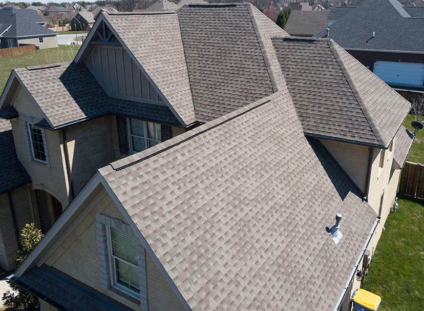 Rooftop view of a suburban home with asphalt shingles.