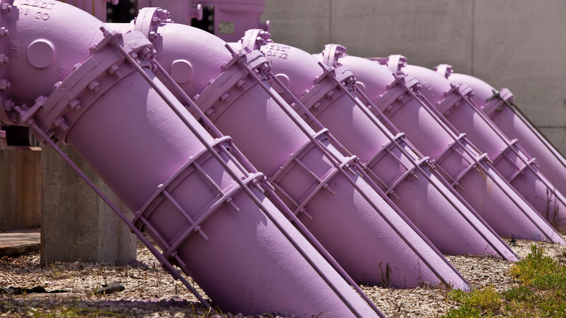 Purple pipes slanted in a row for reclaimed water use.