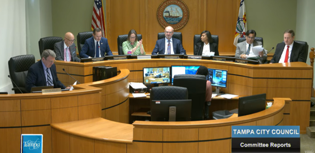 Tampa City Council meeting in session with members seated at a large wooden desk.