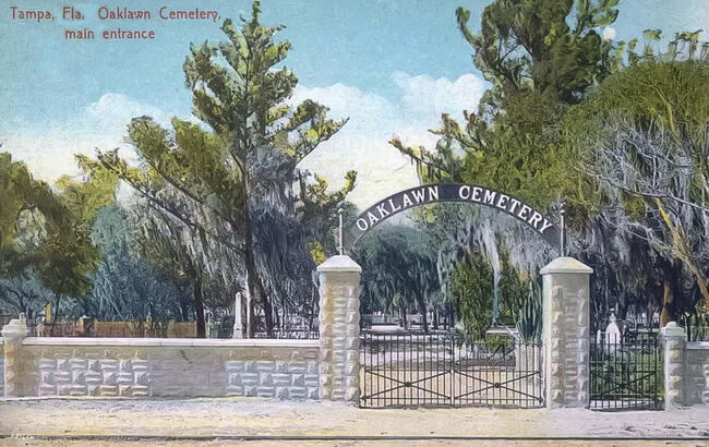 Oaklawn Cemetery entrance postcard with trees and stone pillars.