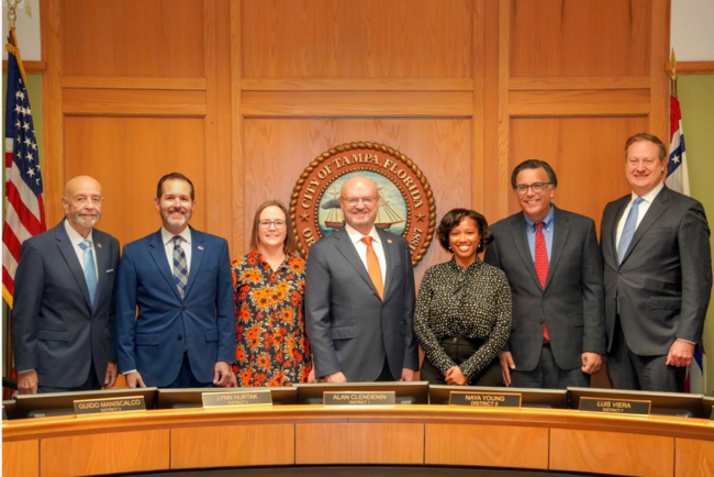 Council members standing together, formal setting, 2026.