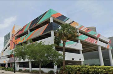 Exterior photograph of the "Stay Curious" mural that is painted on the facade of the Poe Garage.