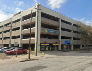 Parking garage exterior under a clear blue sky