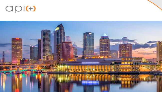 Tampa skyline at dusk with "api(+)" logo at the top left.