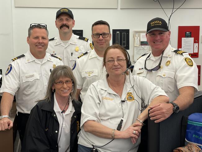 Emergency response team in white uniforms smiling together.