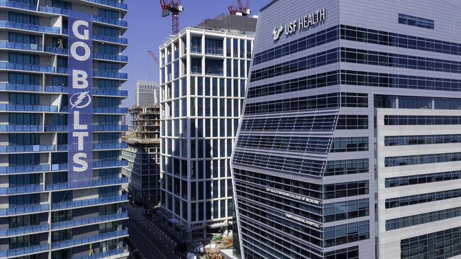 Water Street Tampa and USF Health with cranes in the background
