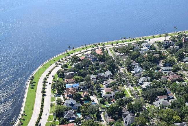 Aerial view of coastal land use and infrastructure near a waterfront.