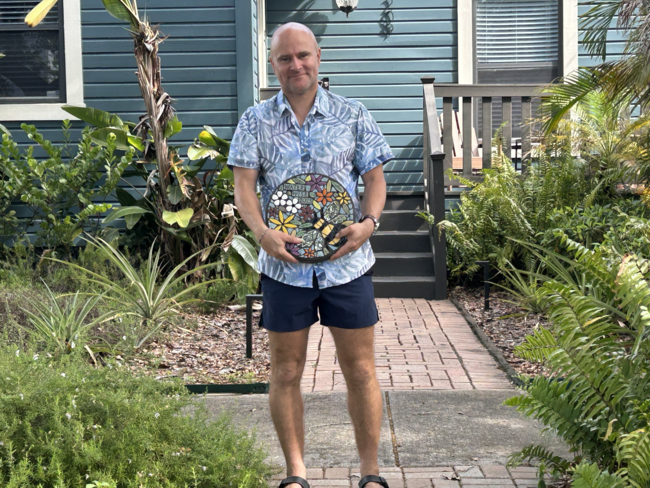 Ingo Fochler, one of the 2025 Community Water Wise Award winners, holding his awarded round Waterwise 2025 mosaic stone.