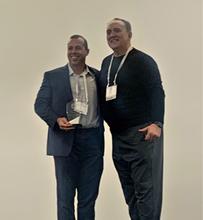 Juan Lopez receiving award alongside Morgan Christopher, Managing Director for CSPI
