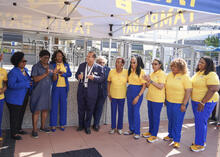 Group gathers including Hillsborough County Commissioner Gwen Myers, Tampa Convention Center Sales and Marketing Manager Juan Lopez, and Sigma Gamma Rho leadership during a presentation of a covered commemorative paver on the Riverwalk.