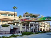 Convention center building with a colorful "Welcome to Tampa 2026 Imperial Convention" walkway banner and palm trees.