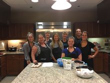 A group of Convention Service Managers and Visit Tampa Bay members post for a quick photo while cooking at the Ronald McDonald House of Tampa