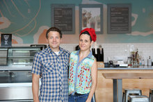 Artists Michelle Sawyer and Tony Krol of Illsol stand in front of their new mural at the Coffee Bar