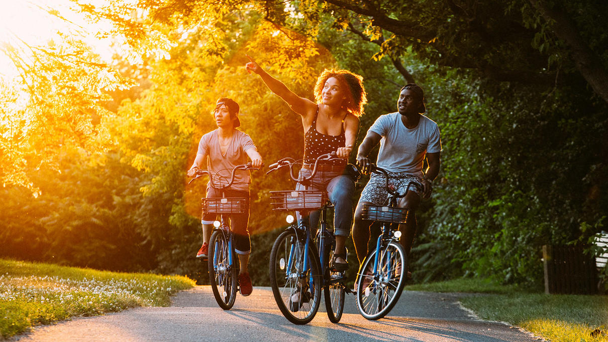 3 people riding Coast bicycles