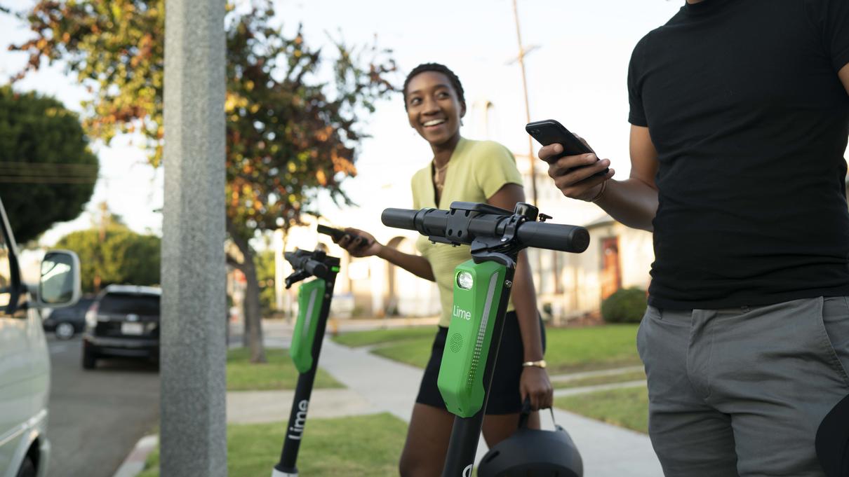 2 people using lime scooters