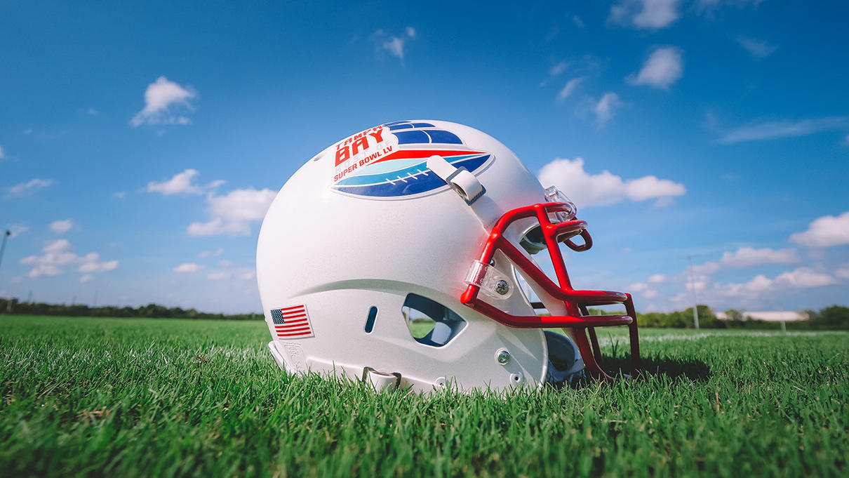 Superbowl helmet on green field with blue skies