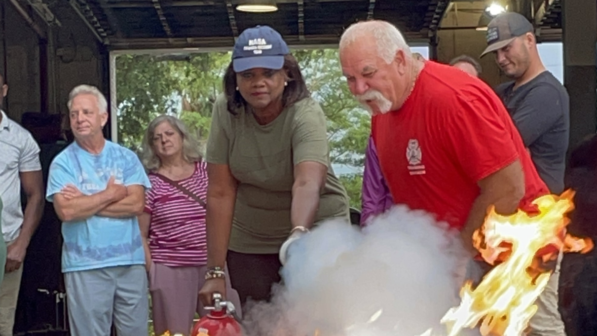 Using a fire extinguisher during a fire safety training.
