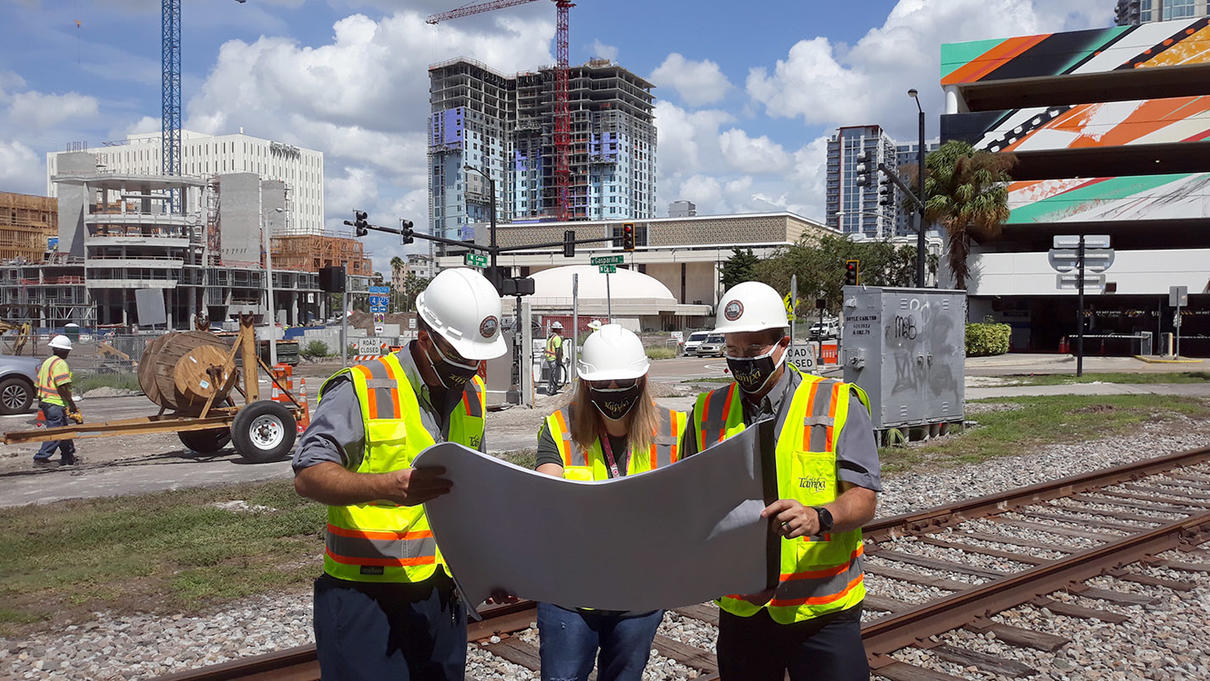 3 construction workers reviewing plans