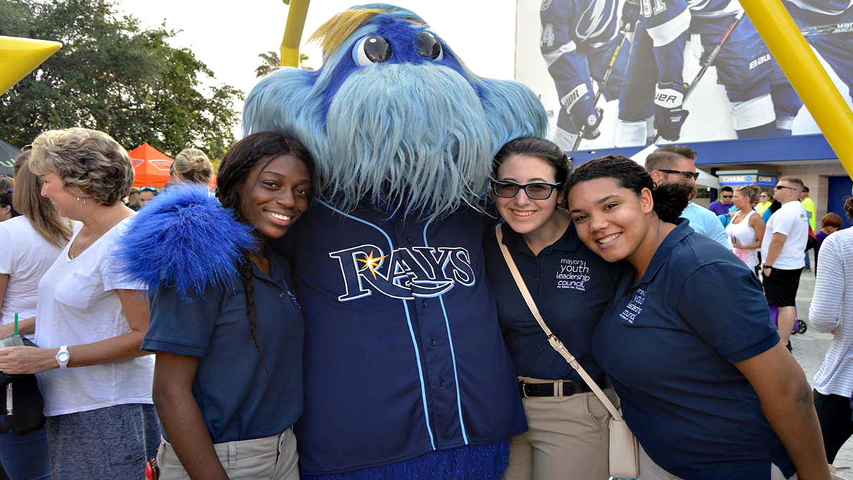 Members grab a snap with the Tampa Rays mascot, Raymond!