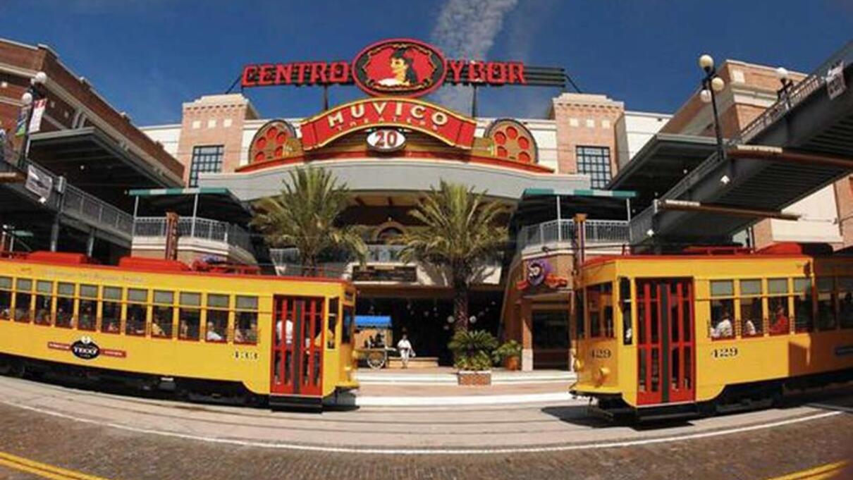 Two yellow streetcars in front of Centro Ybor in Tampa's Ybor City district.