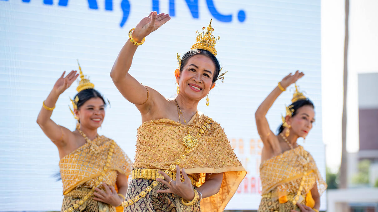 Women in traditional attire perform a cultural dance at an Asian Pacific event in Tampa.