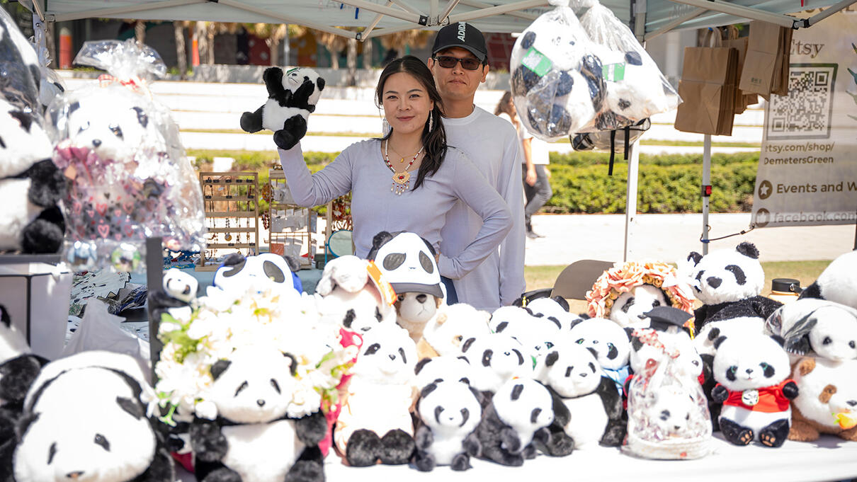 Pandas at Tampa Asian Pacific festival booth under a canopy.