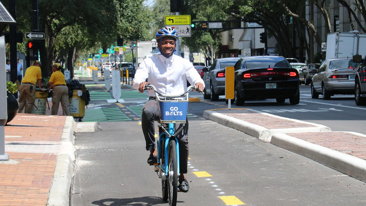 Man riding bicycle on urban bicycle lane